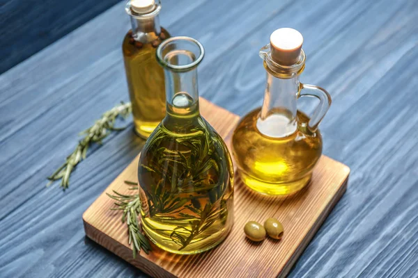 Bottle with olive oil and herbs — Stock Photo, Image