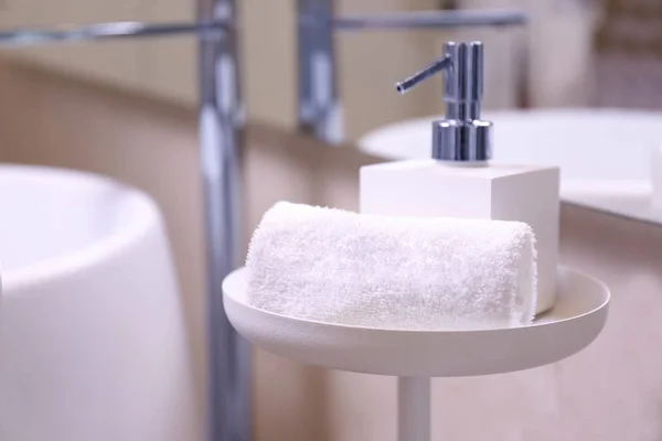 Soap dispenser and towel in modern spa salon — Stock Photo, Image