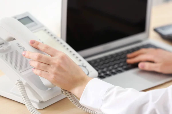 Hand picking up telephone receiver — Stock Photo, Image