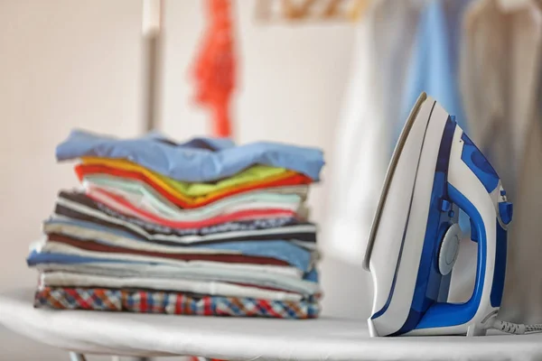 Iron and clean clothes on board — Stock Photo, Image