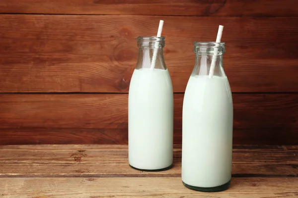 Two bottles of milk with straws