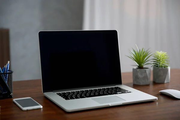 Modern laptop on desk — Stock Photo, Image