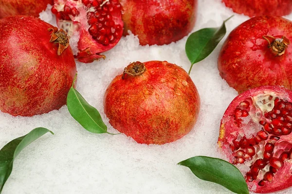 Delicious pomegranates with leaves — Stock Photo, Image