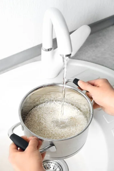 Woman rinsing rice — Stock Photo, Image