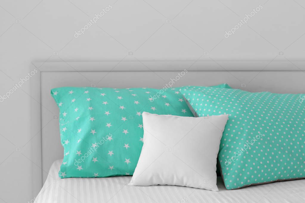 Blank soft pillow on bed