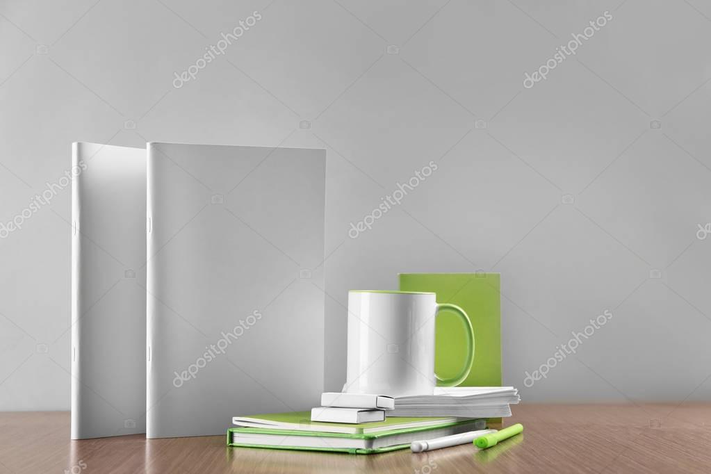 Blank company goods on wooden table