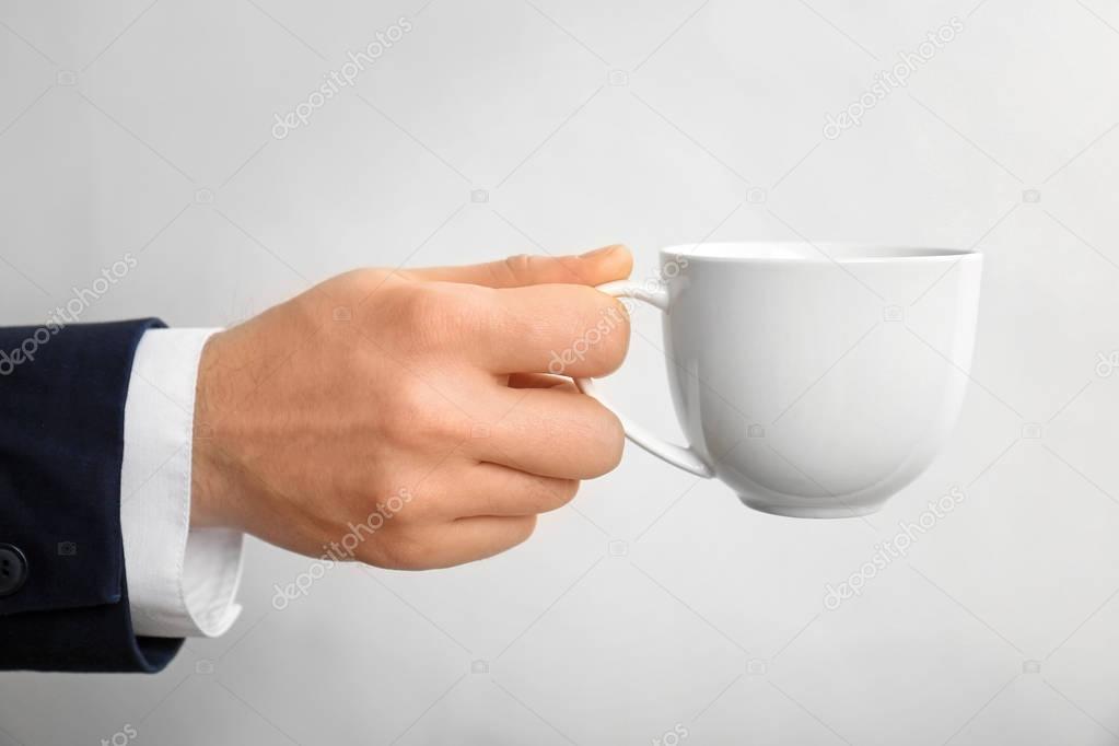 Male hand holding cup