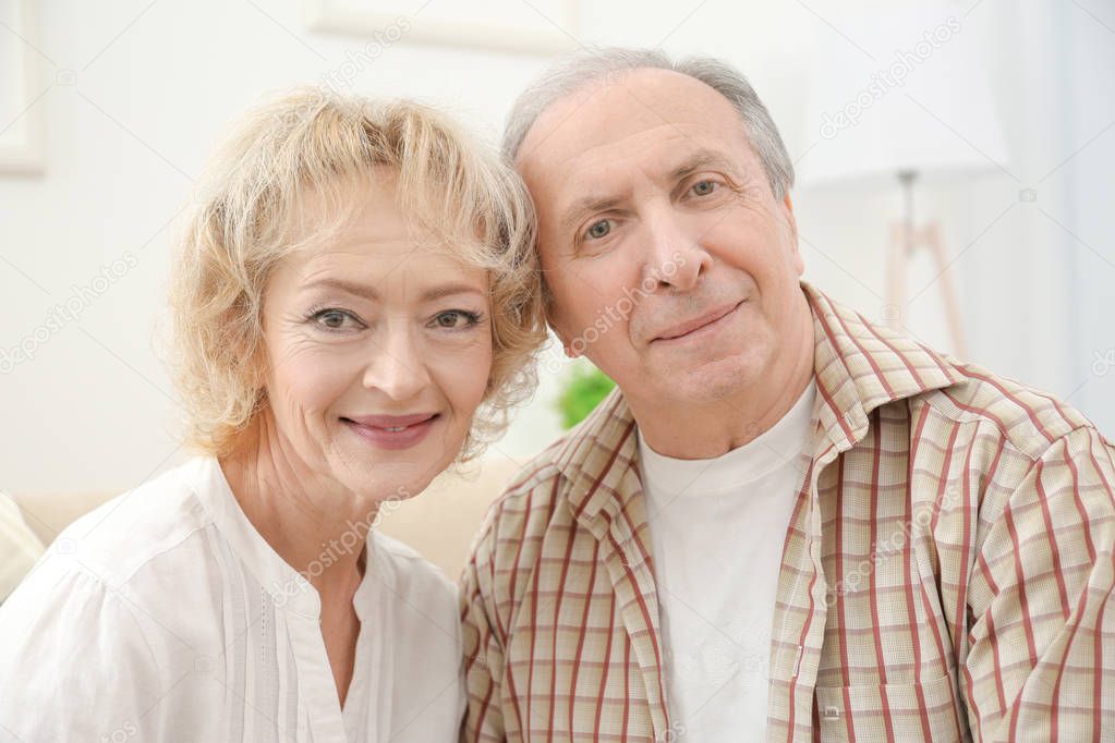 Closeup portrait of happy senior couple at home