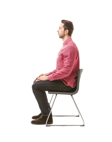 Incorrect posture concept. Man sitting on chair isolated on white — Stock Photo, Image