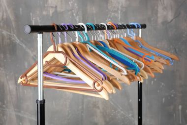 Clothes rail with wooden hangers clipart