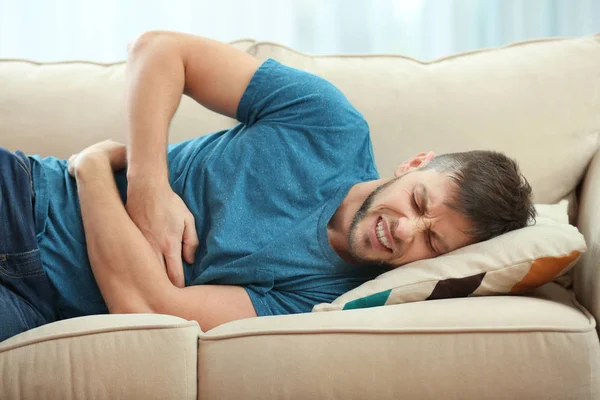 Young man suffering from stomach ache — Stock Photo, Image