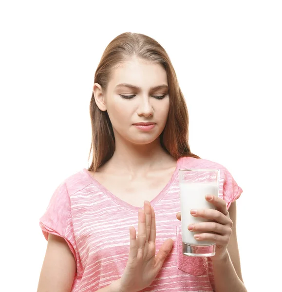 Mulher com alergia leiteira segurando um copo de leite no fundo branco — Fotografia de Stock