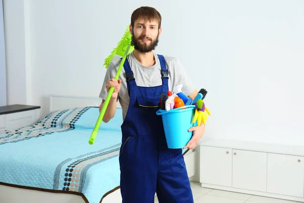 Young man with cleaning supplies — Stock Photo, Image