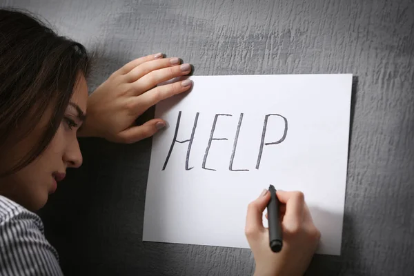 Woman writing word HELP — Stock Photo, Image