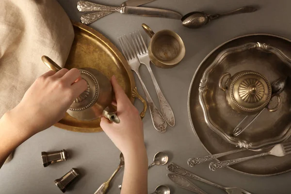 Vintage tableware and female hands — Stock Photo, Image