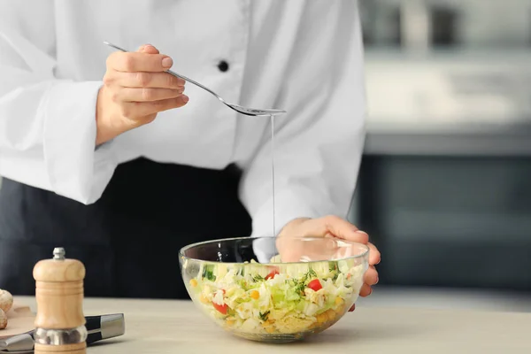 Chef-kok olie toe te voegen aan groente salade — Stockfoto