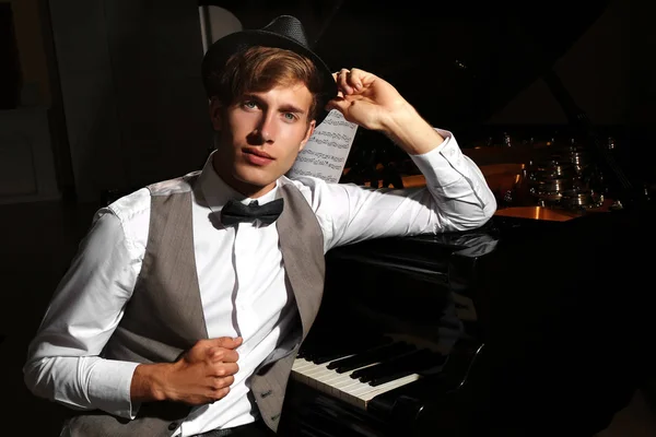 Young musician near piano — Stock Photo, Image