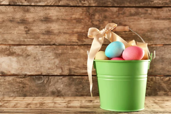 Metal bucket with colorful Easter eggs — Stock Photo, Image