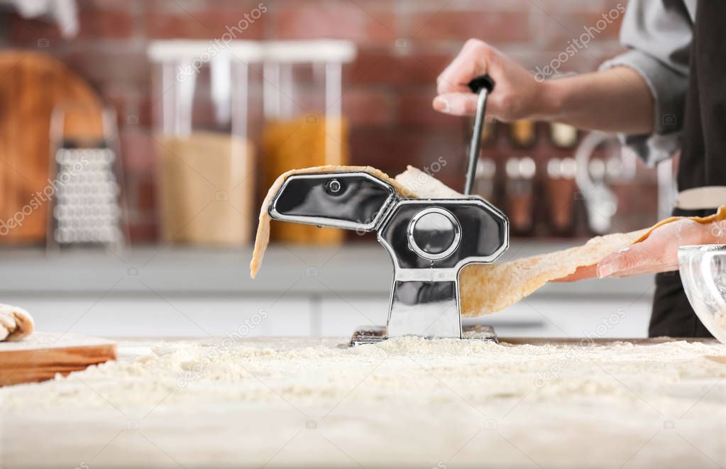Woman rolling dough for pasta