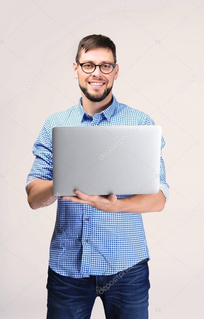 Handsome young programmer with laptop