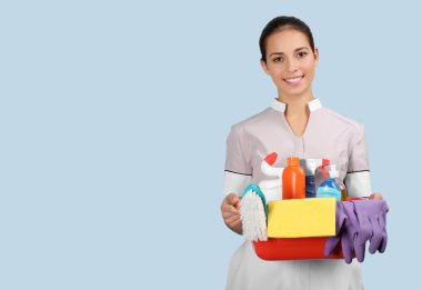 chambermaid holding cleaning supplies 