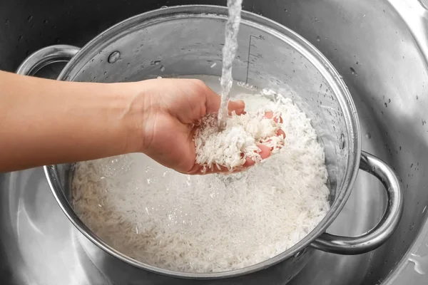 Woman rinsing rice — Stock Photo, Image