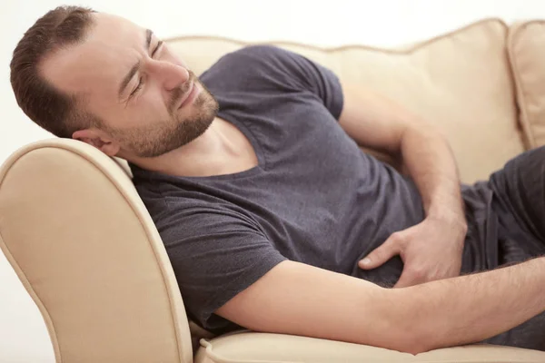 Handsome man suffering from stomach ache — Stock Photo, Image