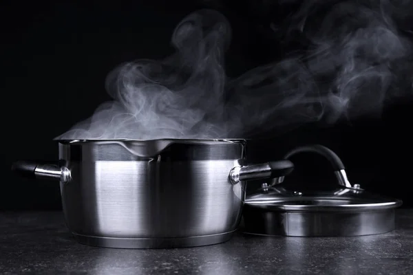 Pan with steam on dark background — Stock Photo, Image