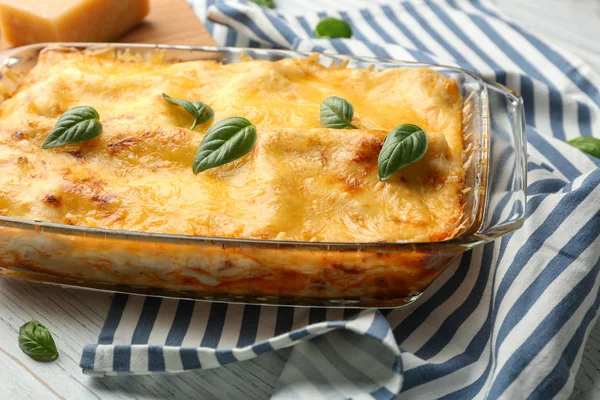 Premium Photo  Woman holding spatula with piece of spinach lasagna over  baking dish