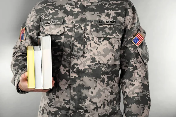 Soldado sosteniendo libros — Foto de Stock