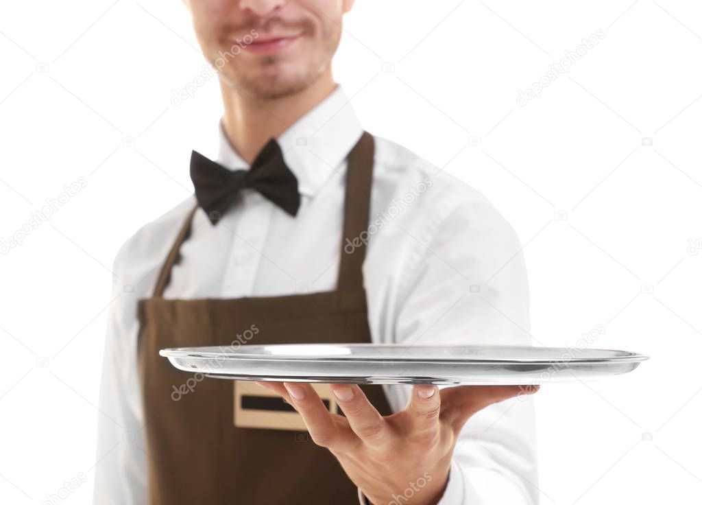 Waiter holding empty silver tray over white background.Focus on the tray