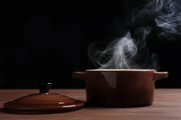 Pan with steam on dark background — Stock Photo, Image