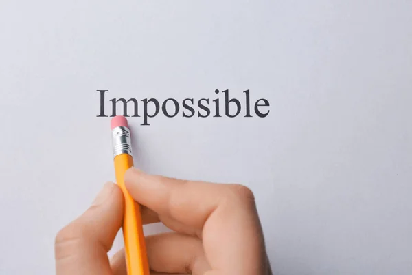 Hand erasing word impossible — Stock Photo, Image