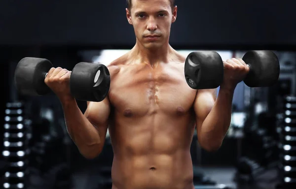 Homem treinando com halteres — Fotografia de Stock