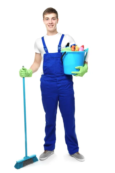 Young man holding cleaning equipment and supplies on white background — Stock Photo, Image