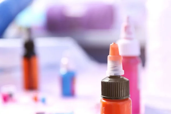 Bottles with colorful inks for tattoo, closeup — Stock Photo, Image