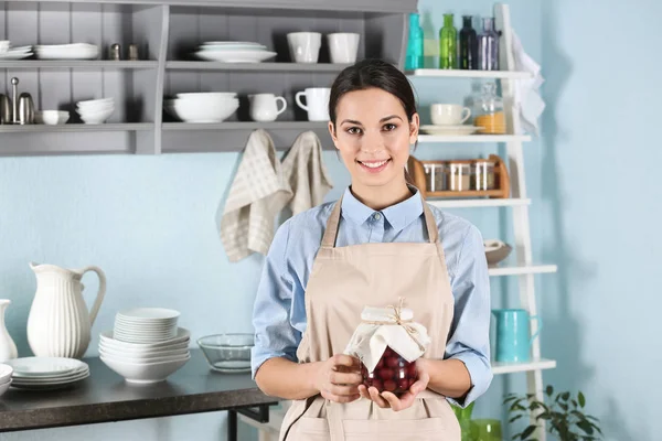 Woman holding jar with jam — Stock Photo, Image