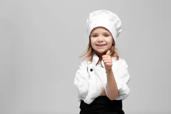 Menina bonito em uniforme chef — Fotografia de Stock