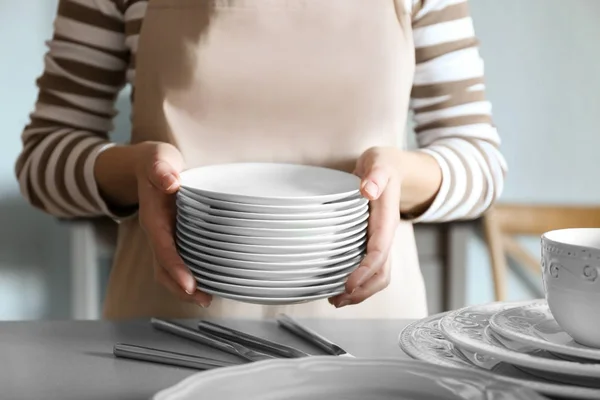 Female hands holding saucers — Stock Photo, Image