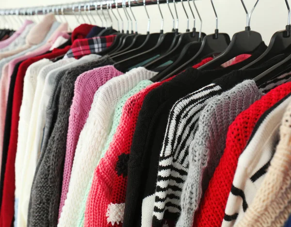 Clothes on hangers in modern shop — Stock Photo, Image