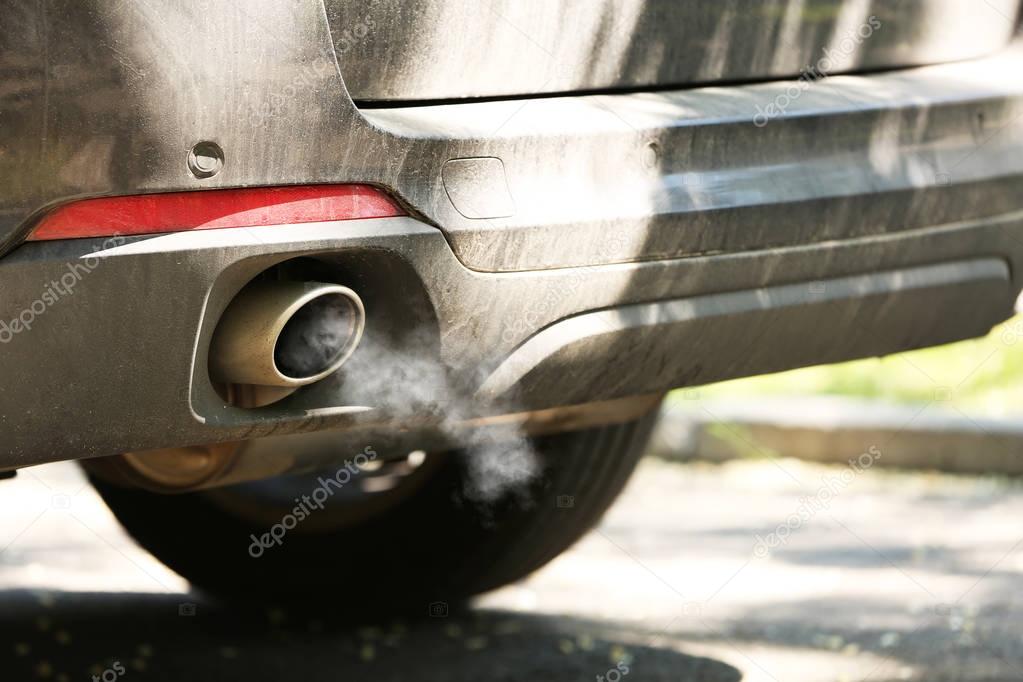 Combustion gas from car exhaust pipe, closeup