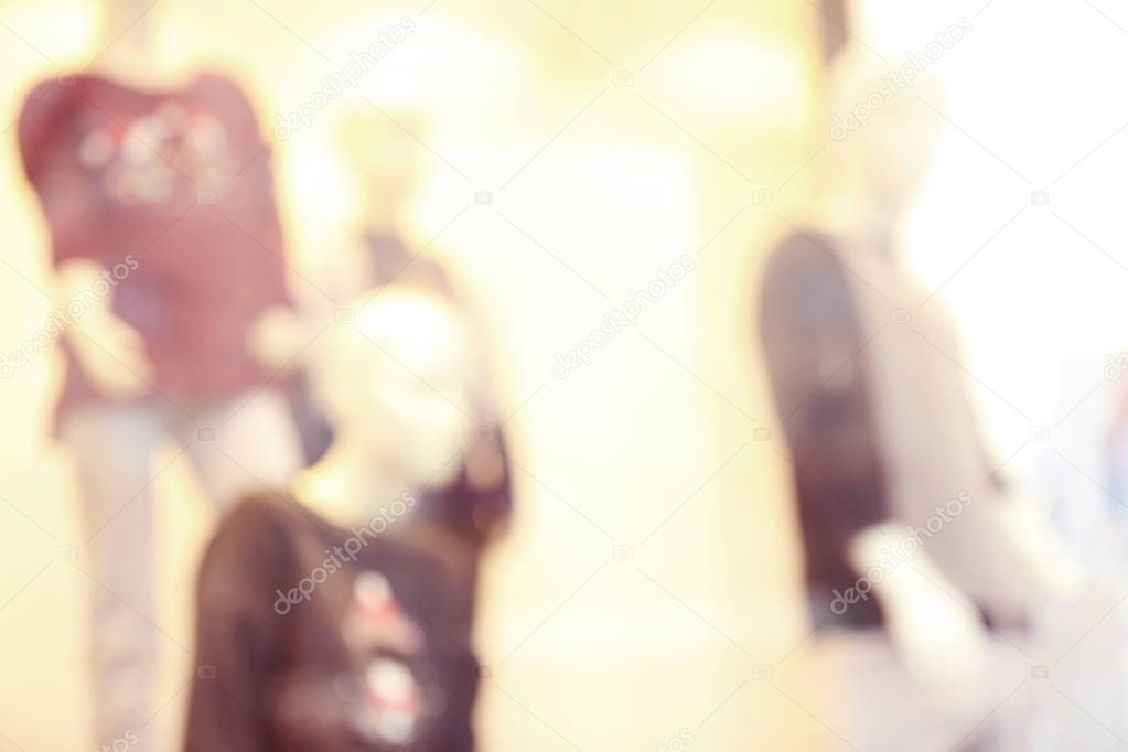 Blurred background of fashion store showcase with mannequins