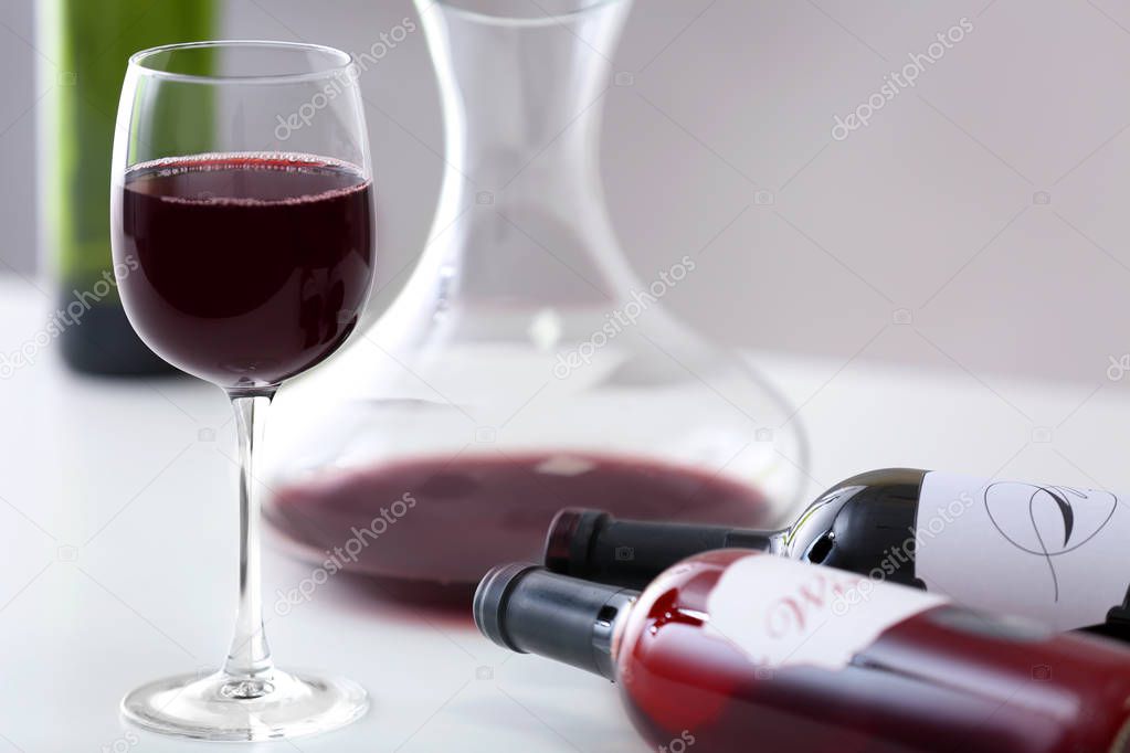 wineglass and bottles of red wine