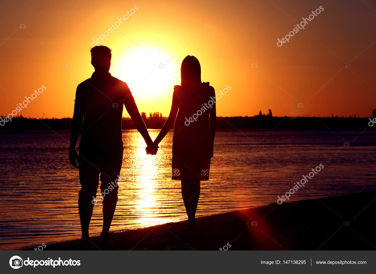 Young Couple In Love On Summer Sunset Beach Stock Photo