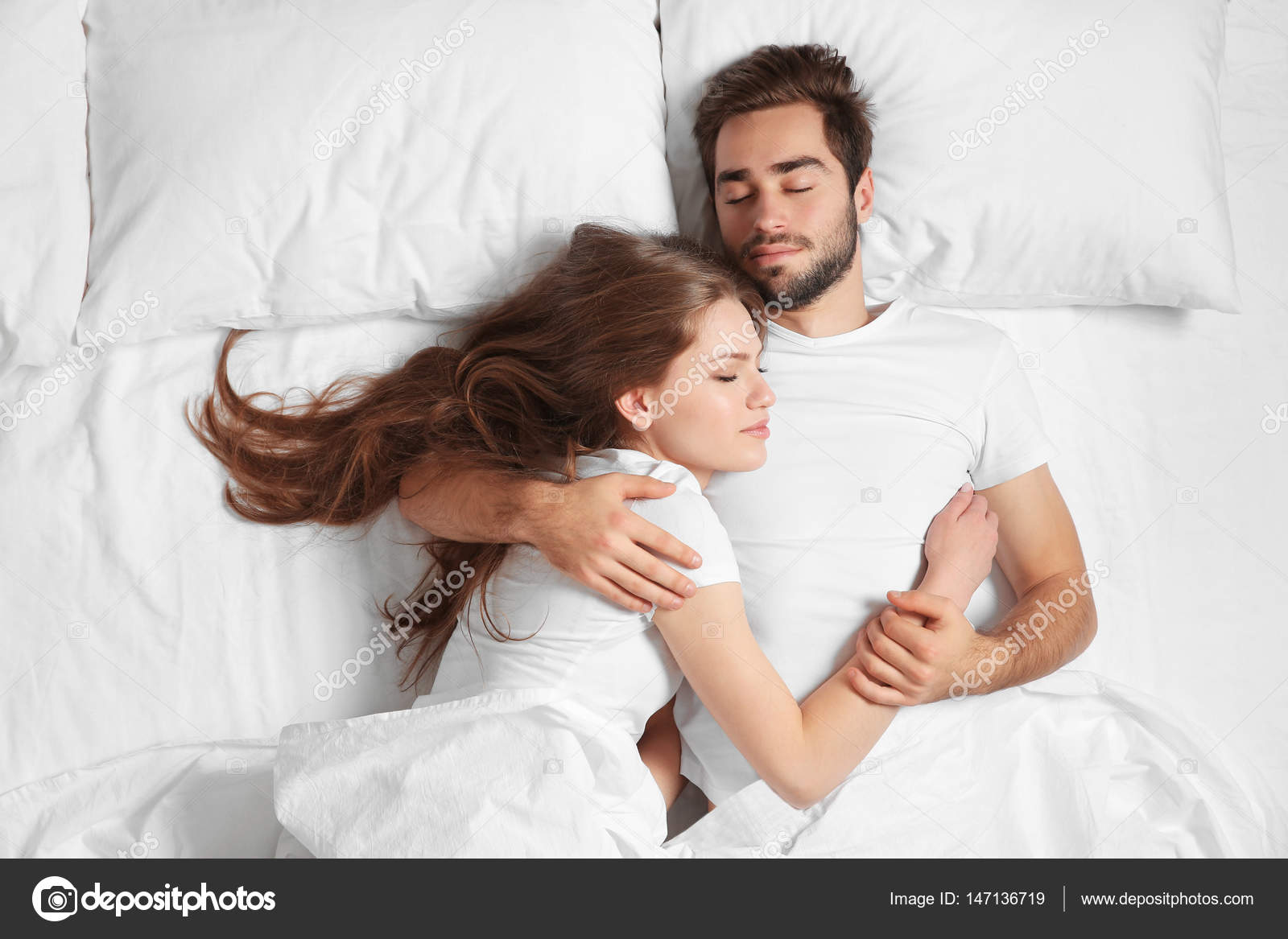 Young cute couple in bed Stock Photo by ©belchonock 147136719