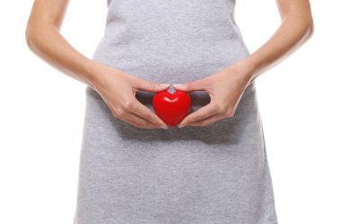 Close up view of woman with red heart on white background. Gynecology concept clipart