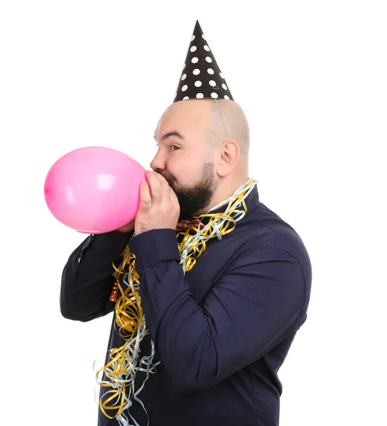 Man with birthday decor inflating balloon — Stock Photo, Image