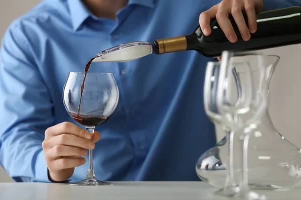 Sommelier pouring red wine