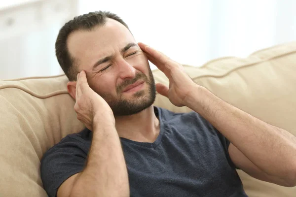 Handsome man suffering from headache — Stock Photo, Image