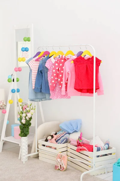 Children clothing in dressing room — Stock Photo, Image